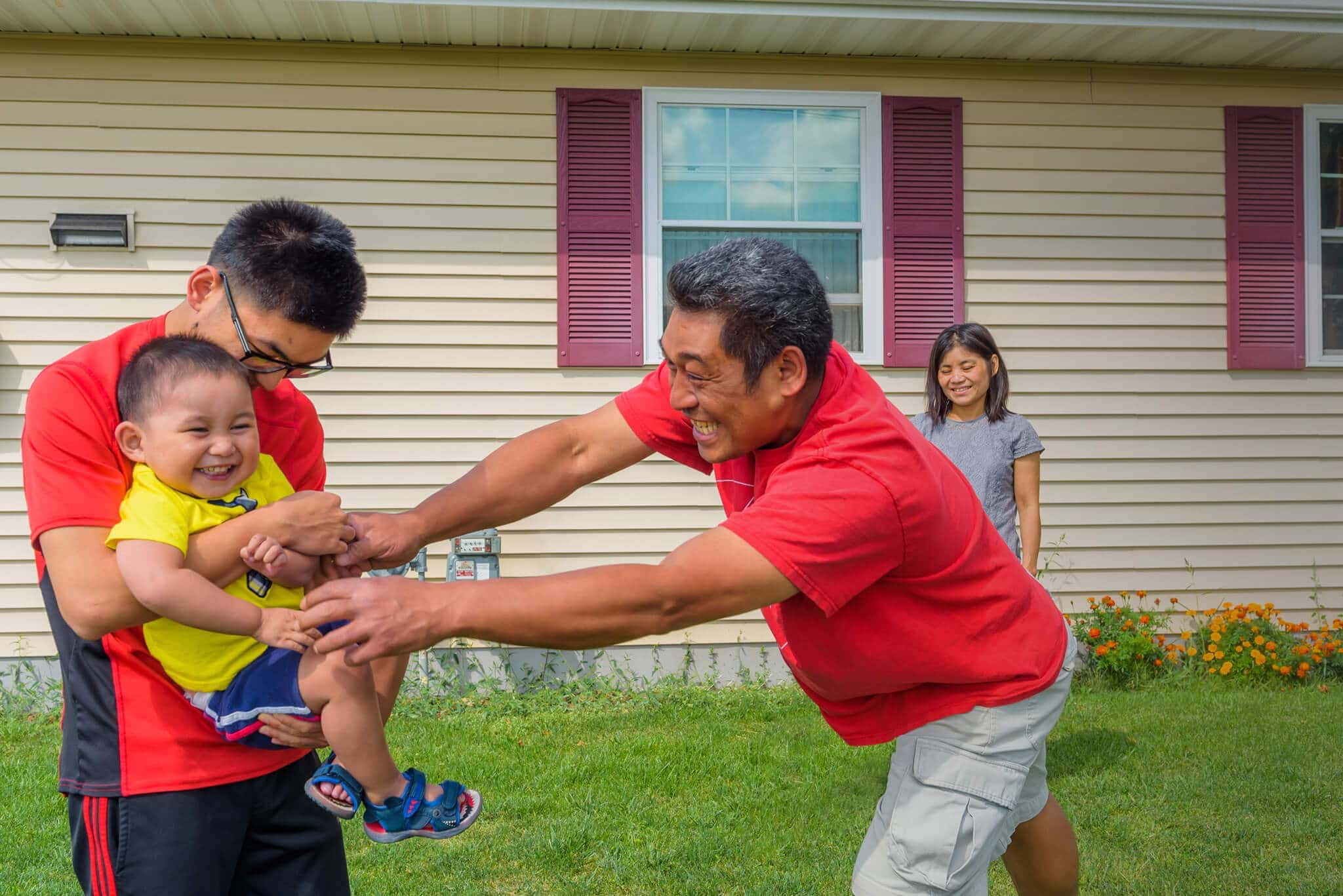 Father playing in the yard with his sons