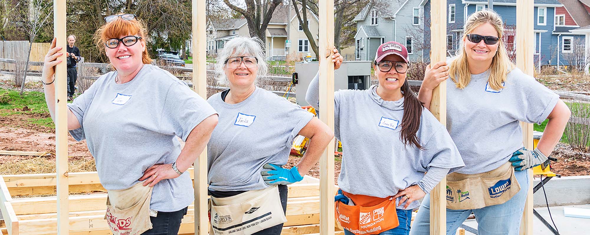 Volunteers working together framing a new home