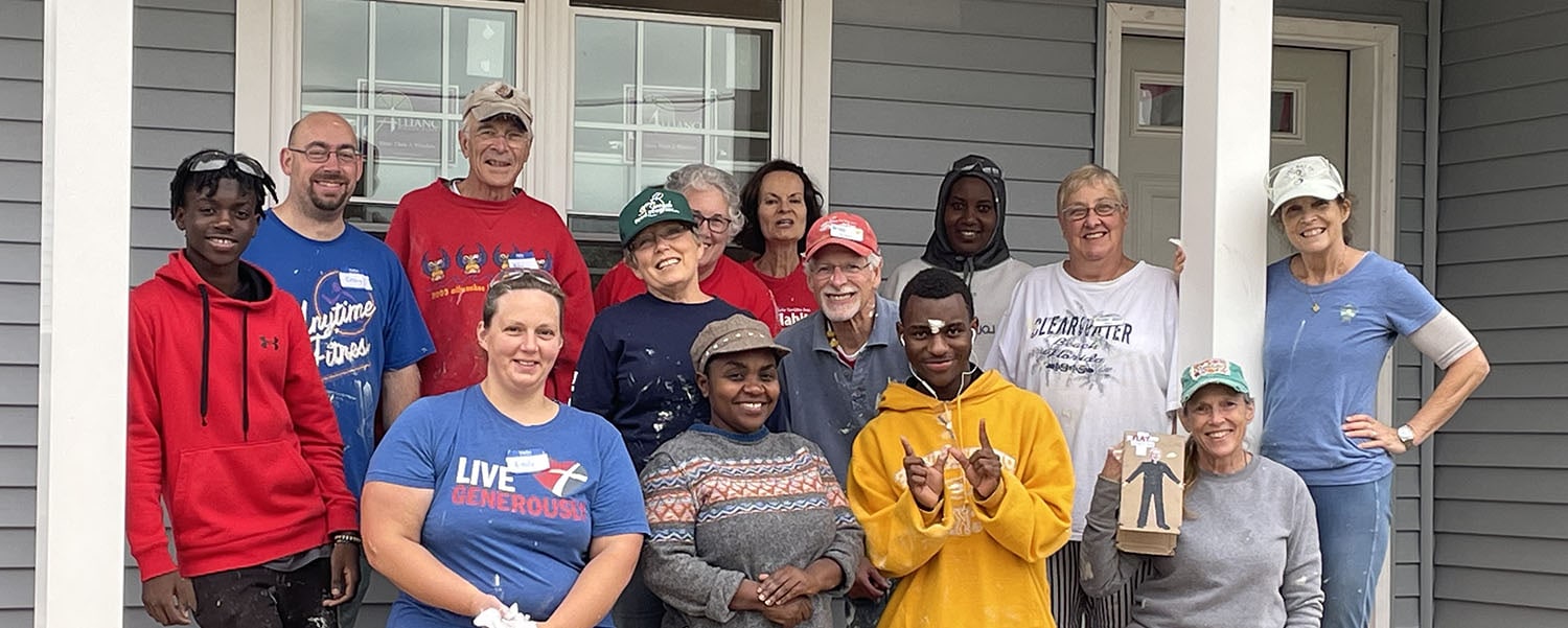 Faith Build participants in front of home