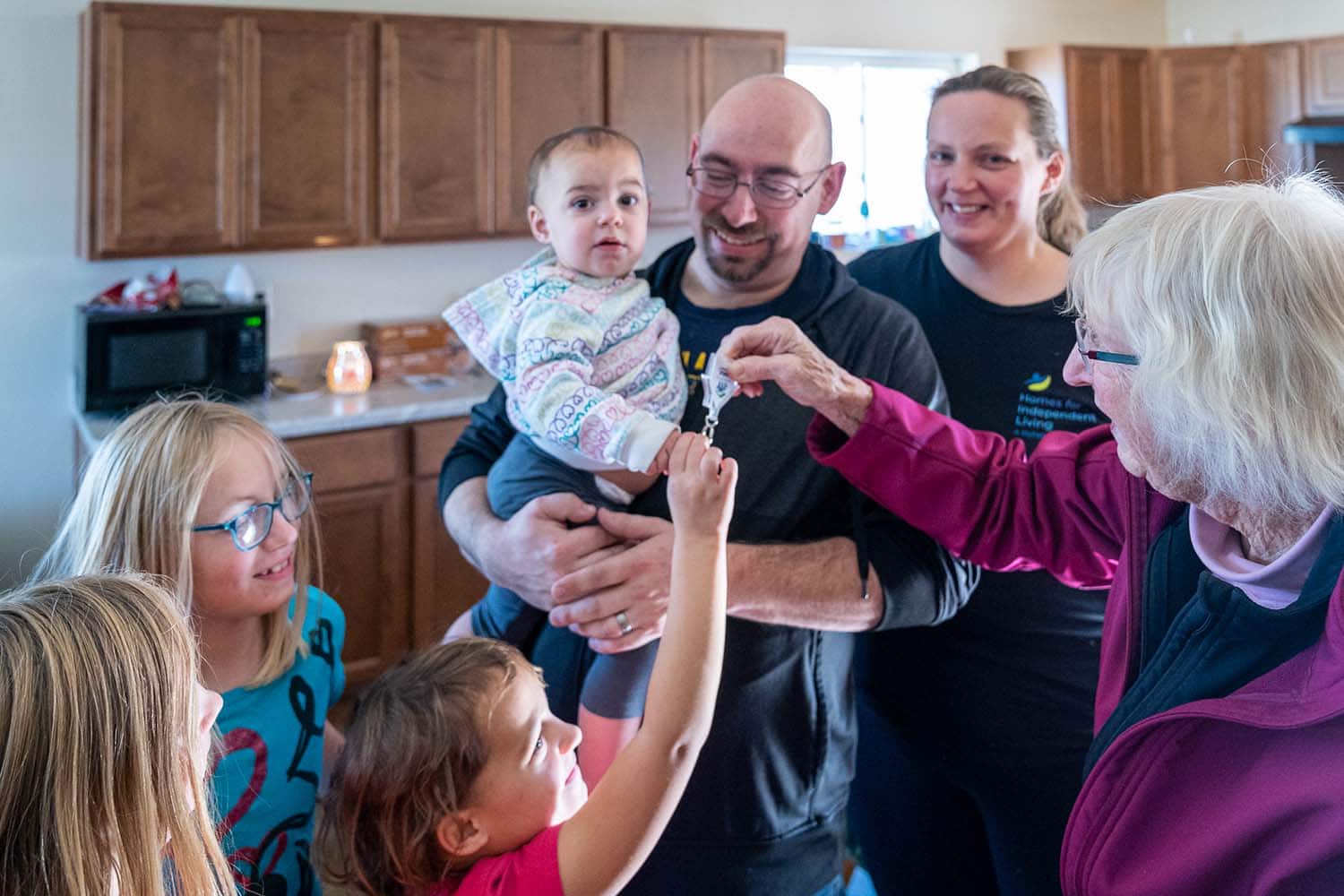 Dellenbach family receiving keys to home