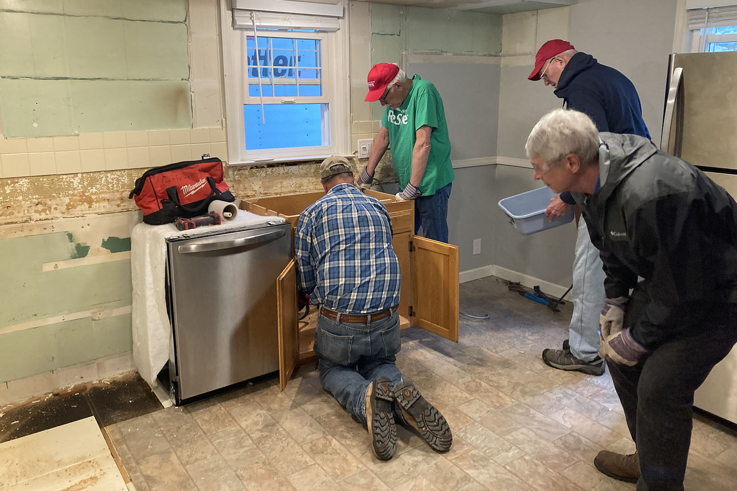 Deconstruction crew removing appliances