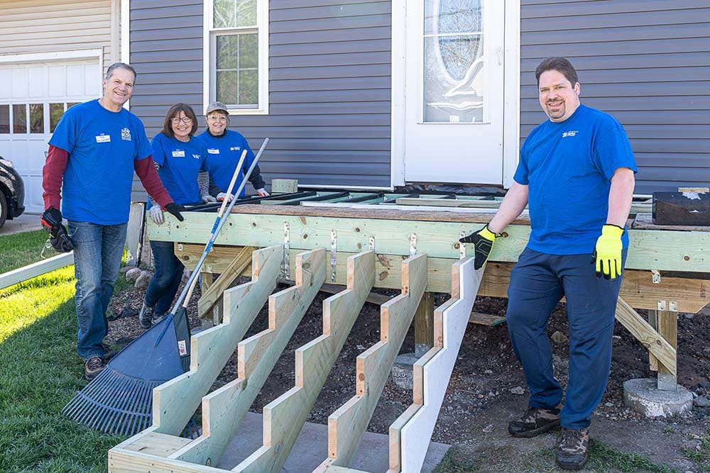 Volunteers working on repairing front porch