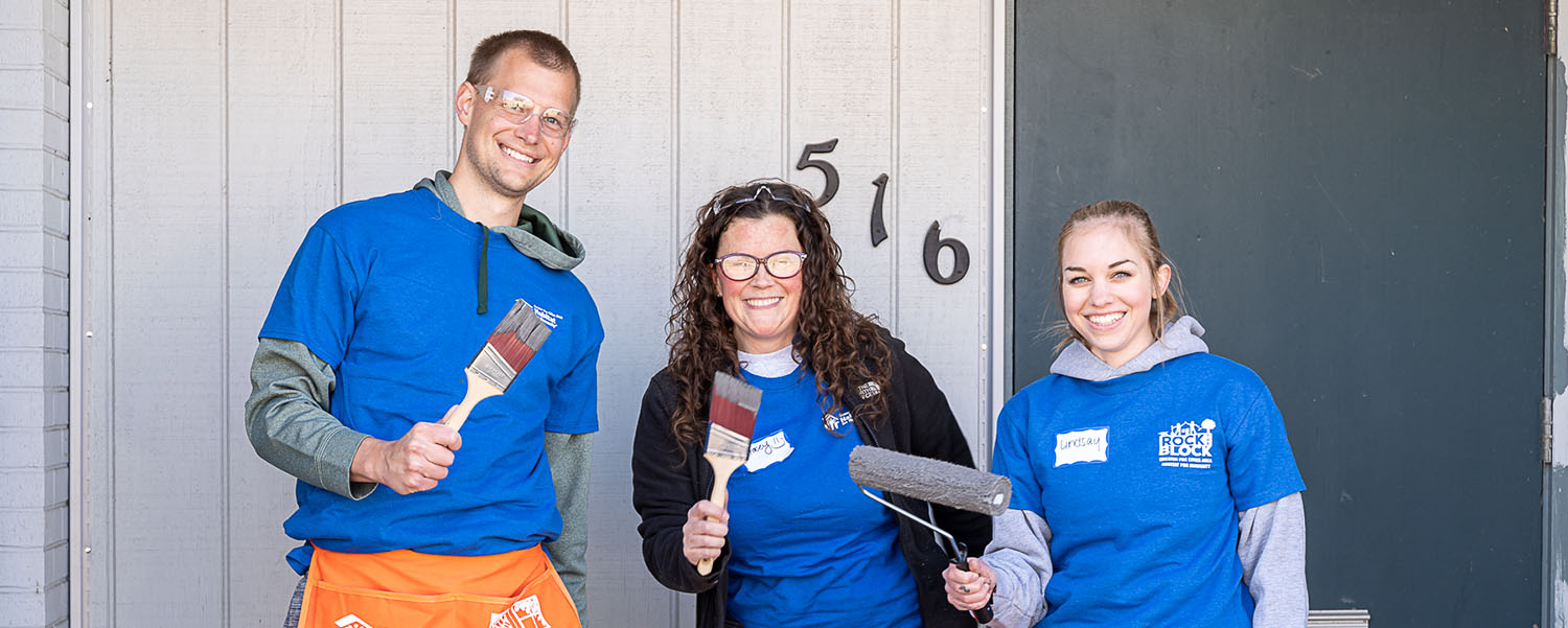 Volunteers painting during Rock the Block event