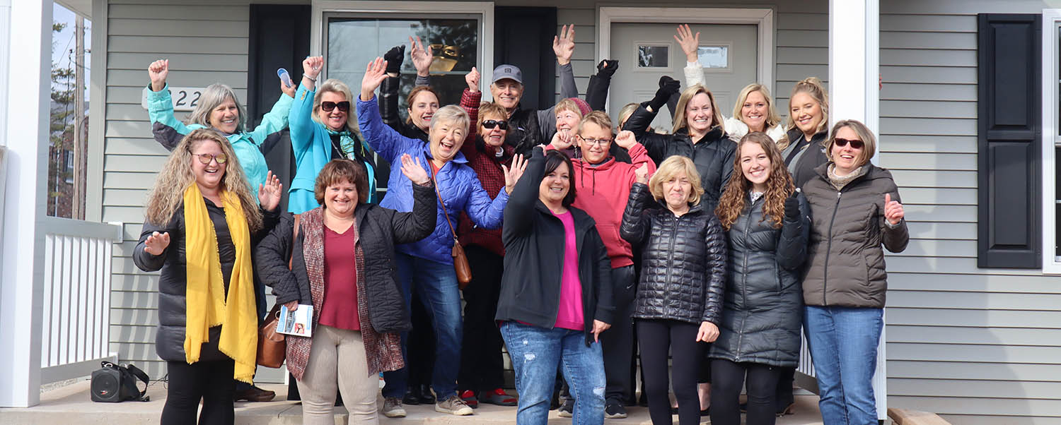 Volunteers posing together with family for 2022 Women Build project