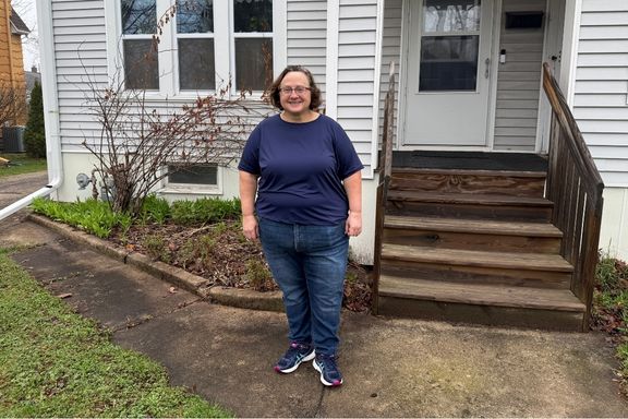 Homebuyer, Karen standing outside of her home